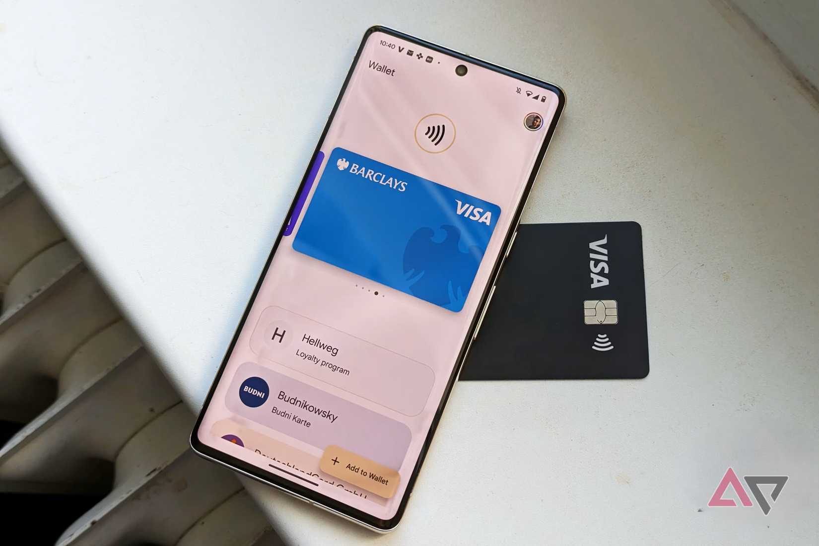 Google Wallet open on a Google Pixel phone resting on top of a black Visa card