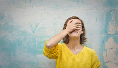 Woman covering face with hands after making mistake