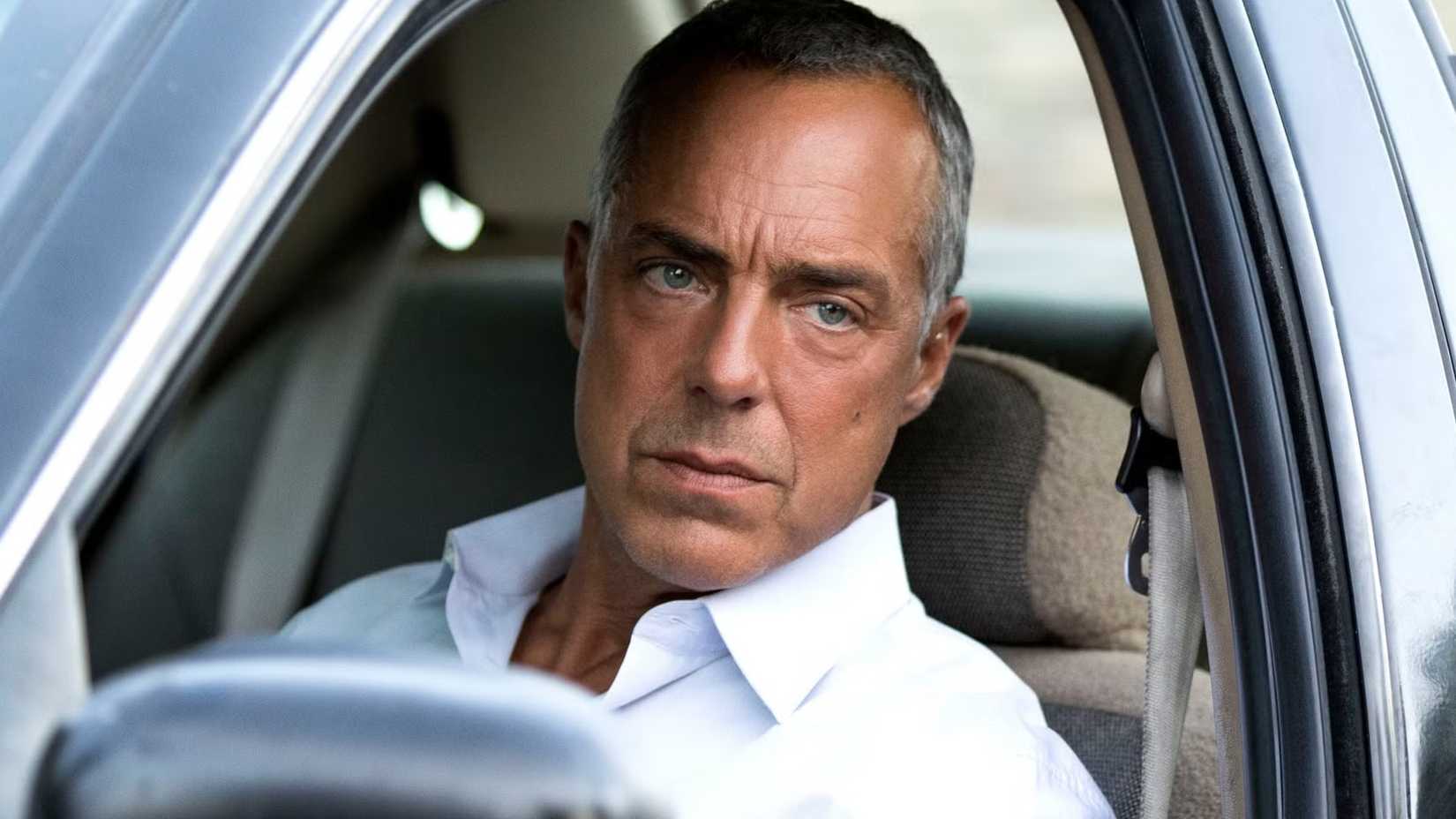 Harry Bosch (Titus Welliver) in his car looking out the window serious in Bosch