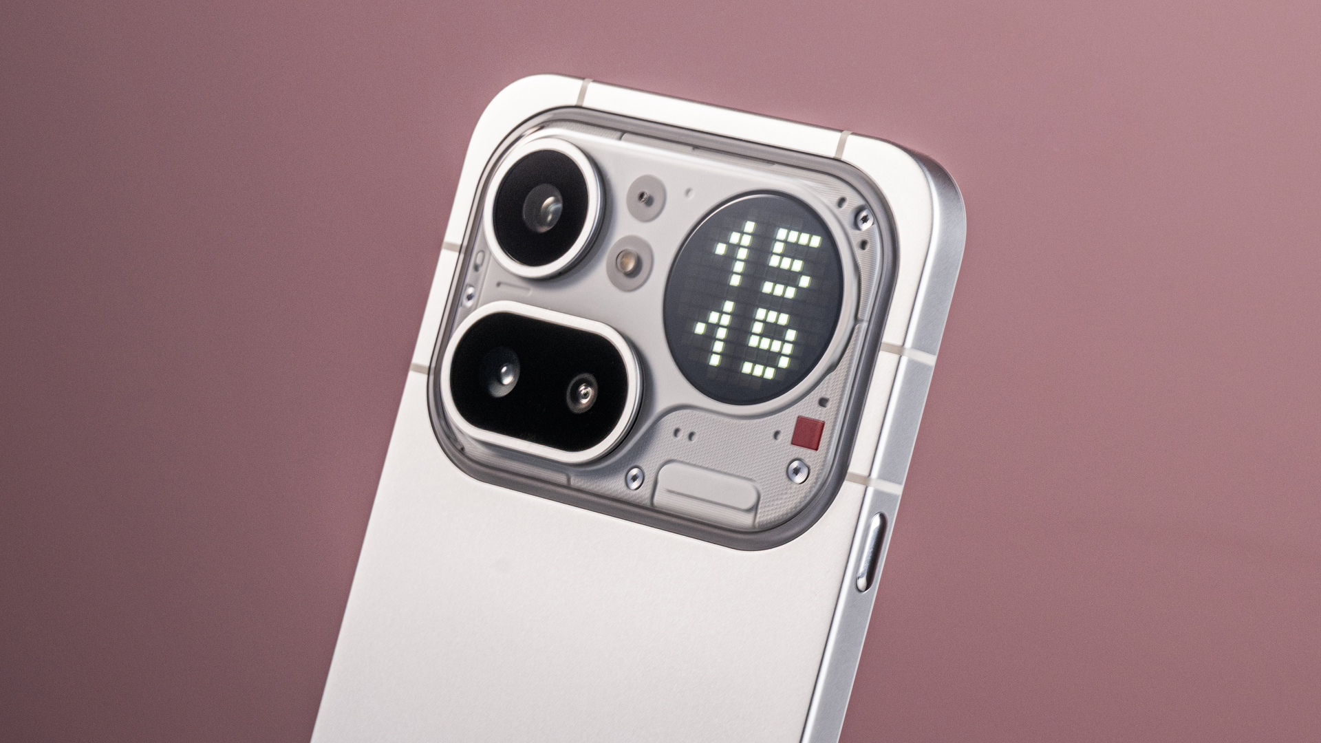A closeup of the Nothing Phone (4a) Pro's camera module and Glyph Matrix, which features a digital clock reading '15:19'.