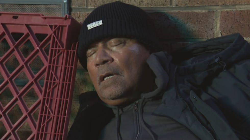 hollyoaks donny clark individual resting against a wall with a red plastic crate nearby
