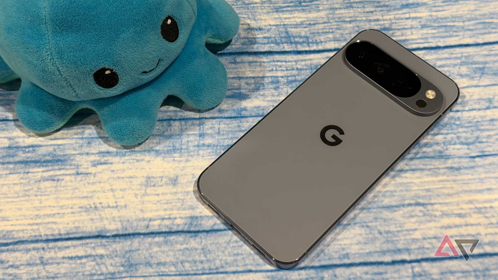 Google Pixel 10 Pro XL next to a smiling plush
