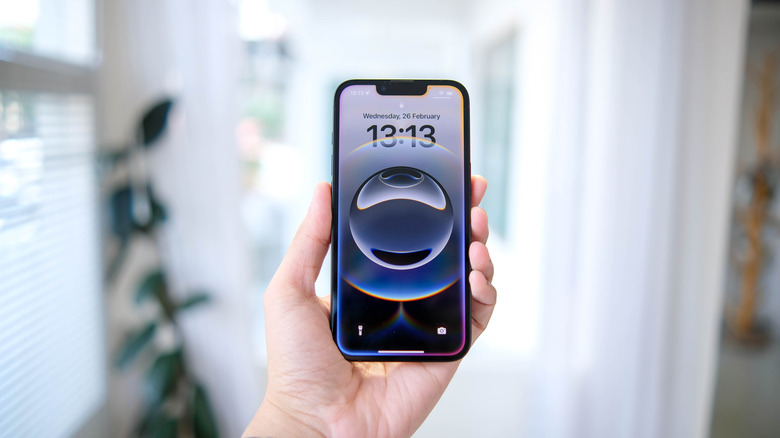 The iPhone 16e in hand.