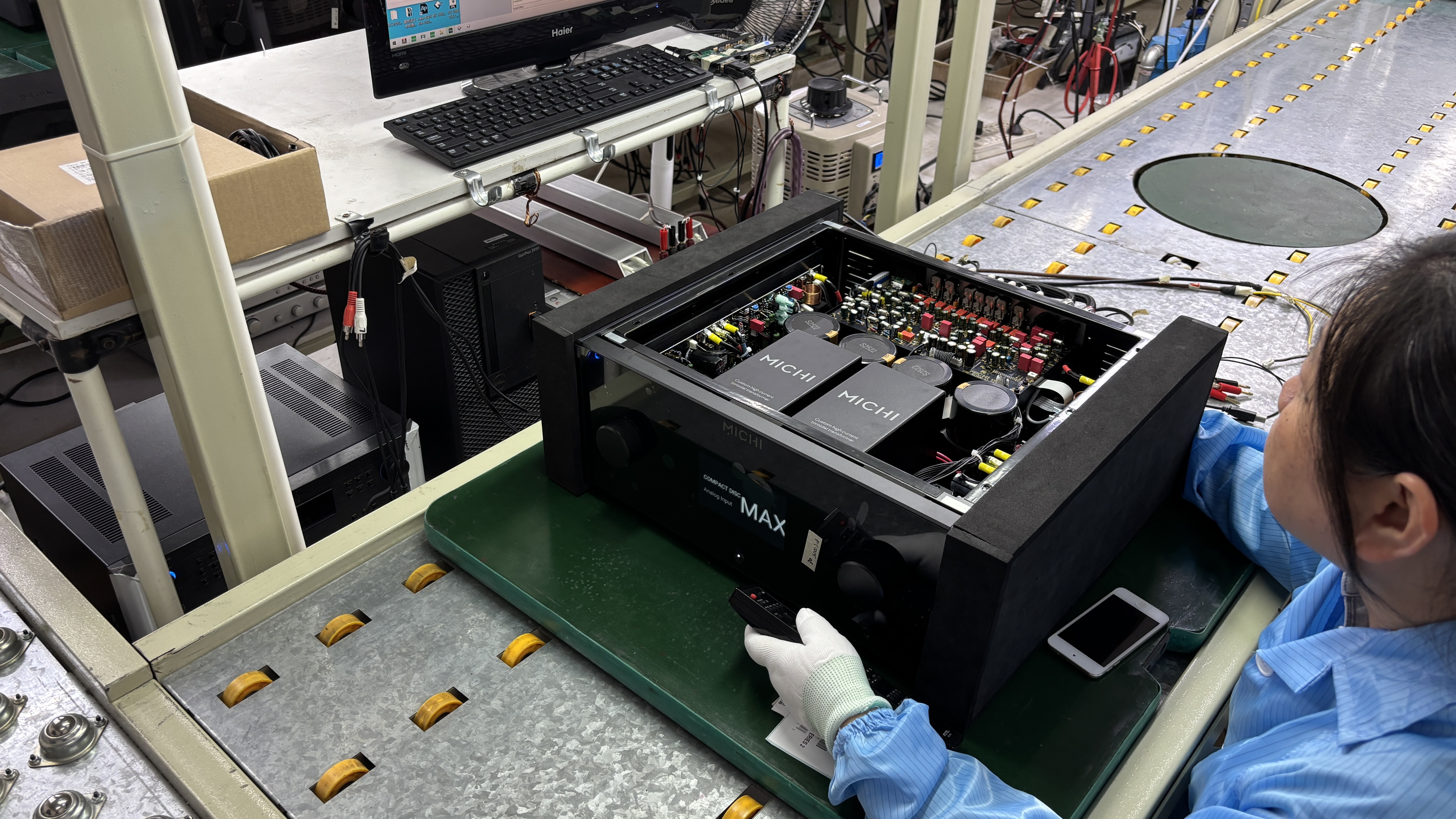 A Michi amplifier being assembled by a factory worker in the Rotel factory