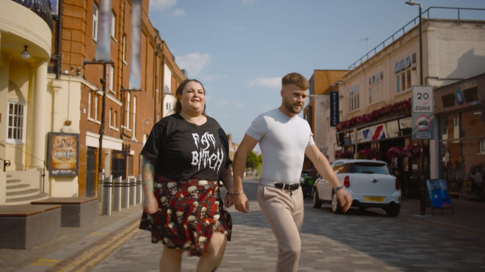 Jo and Reuben two individuals walking hand in hand on a city street