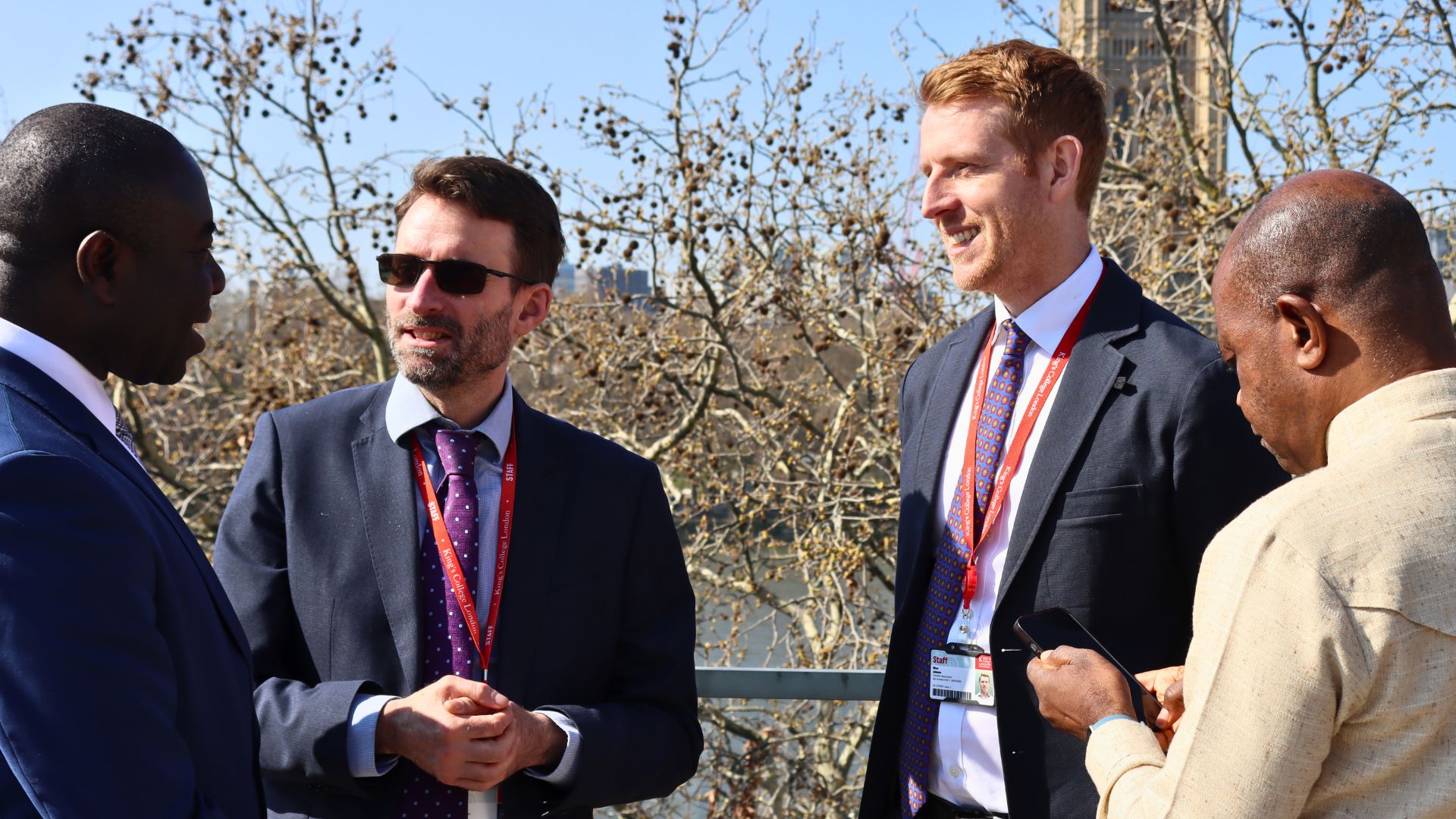 Four men in conversation outside