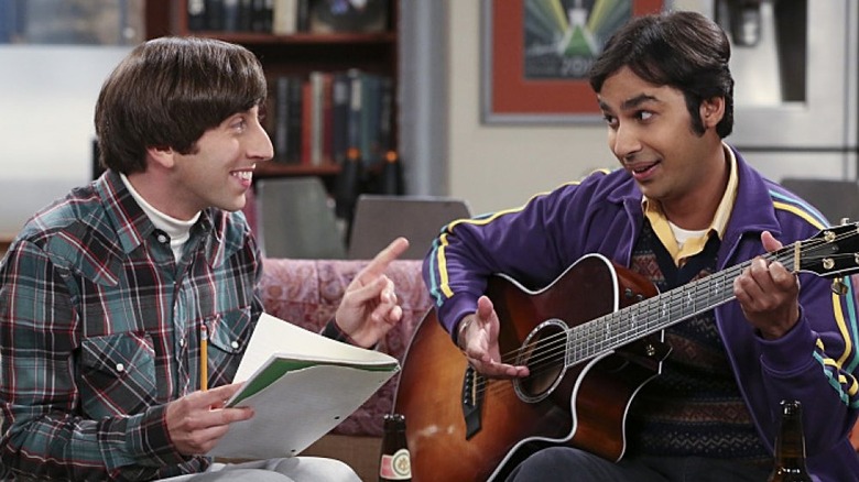 Howard Wolowitz grinning and Raj Koothrappali holding a guitar on The Big Bang Theory