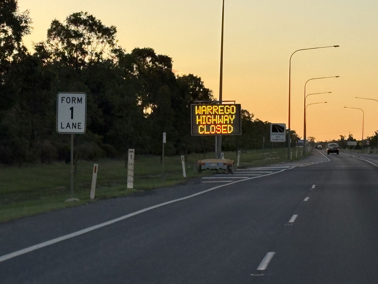 A highway with a warning that reads 'warrego highway closed'