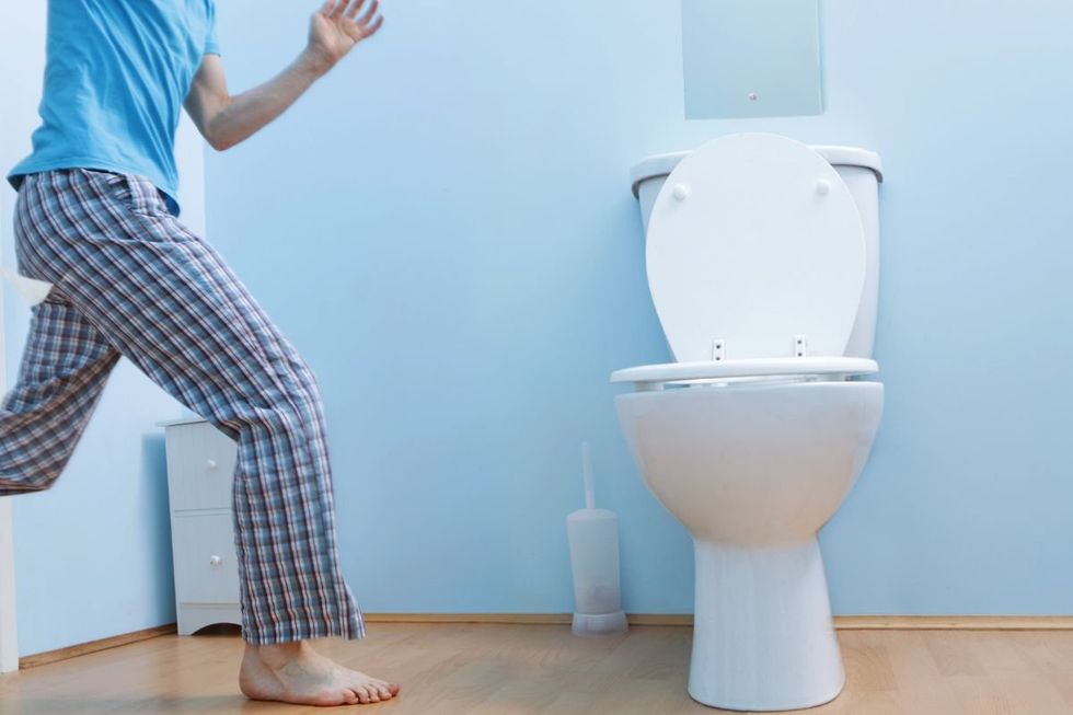MAN RUSHING TO TOILET