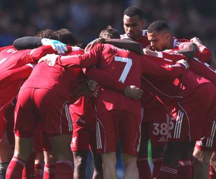 Liverpool players huddle before the match vs Brighton