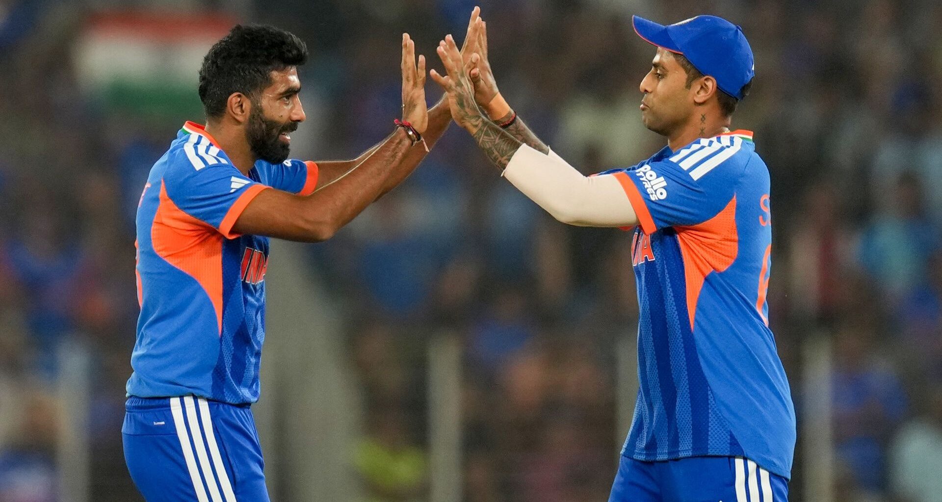 Bowler Jasprit Bumrah and captain Suryakumar Yadav of India celebrate a wicket during an ICC Men's T20 World Cup match.