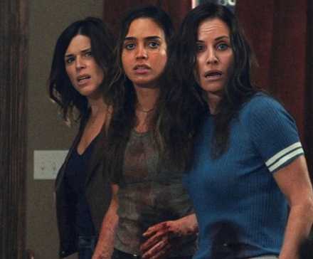 Neve Campbell, Melissa Barrera, & Courteney Cox, bloodied & bruised, look off screen in Scream 5