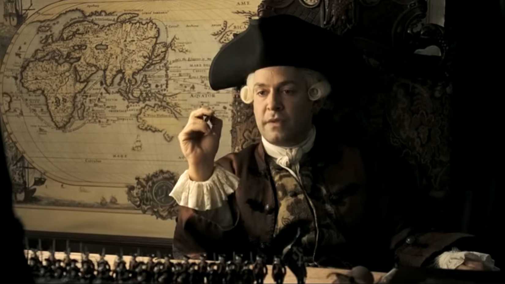 Officer in a pirate hat reviewing battle strategy in Pirates of the Caribbean At Worlds End