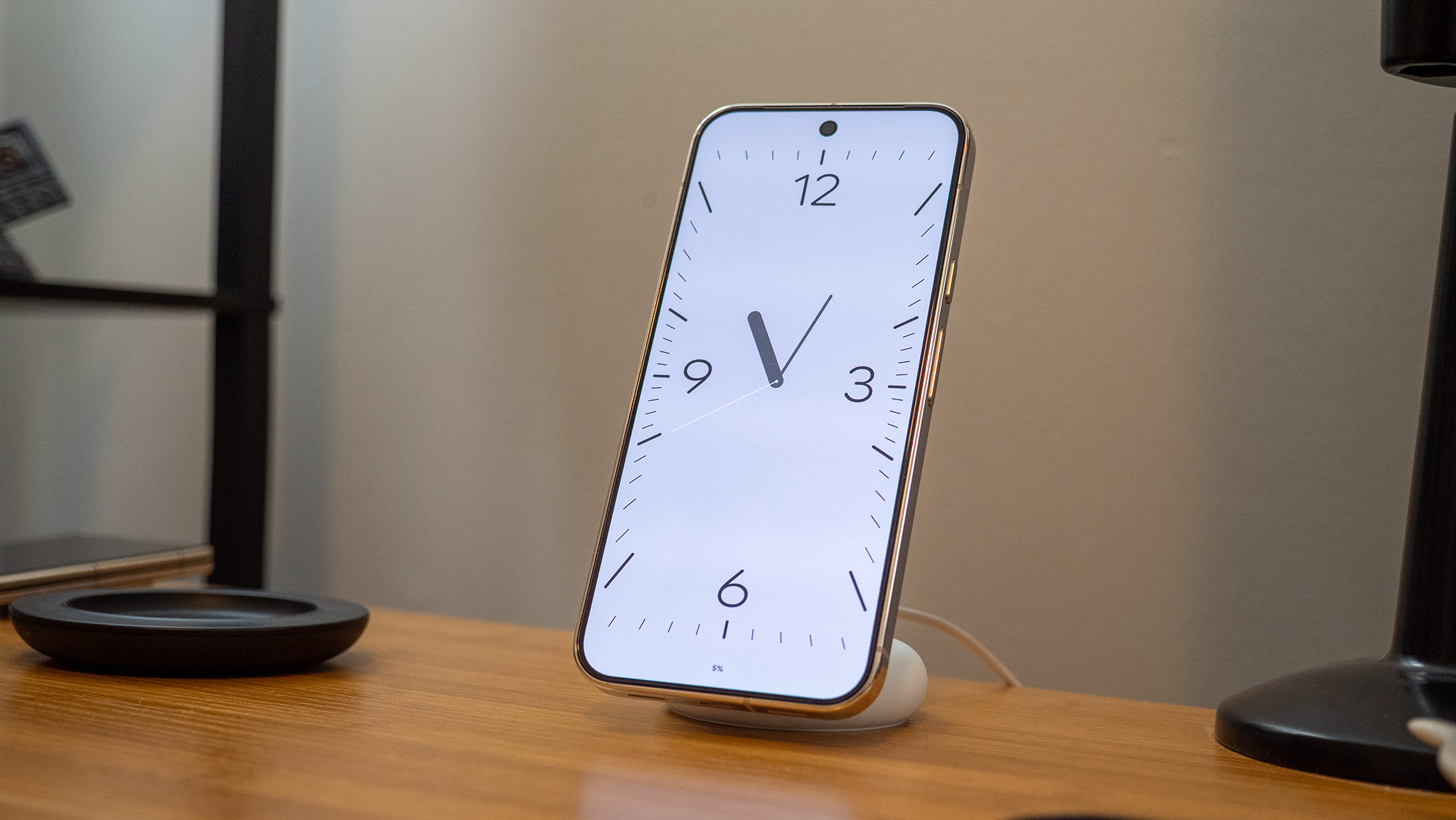 A Google Pixel 10 Pro XL on a Pixelsnap wireless charger with the screensaver function activated