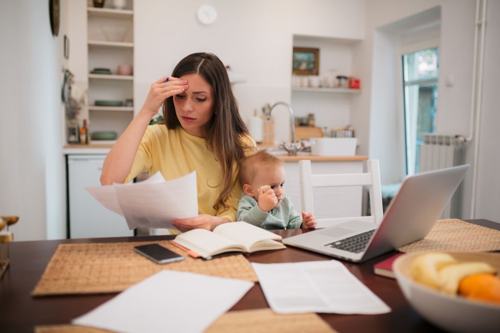 Parent with child looks at letter