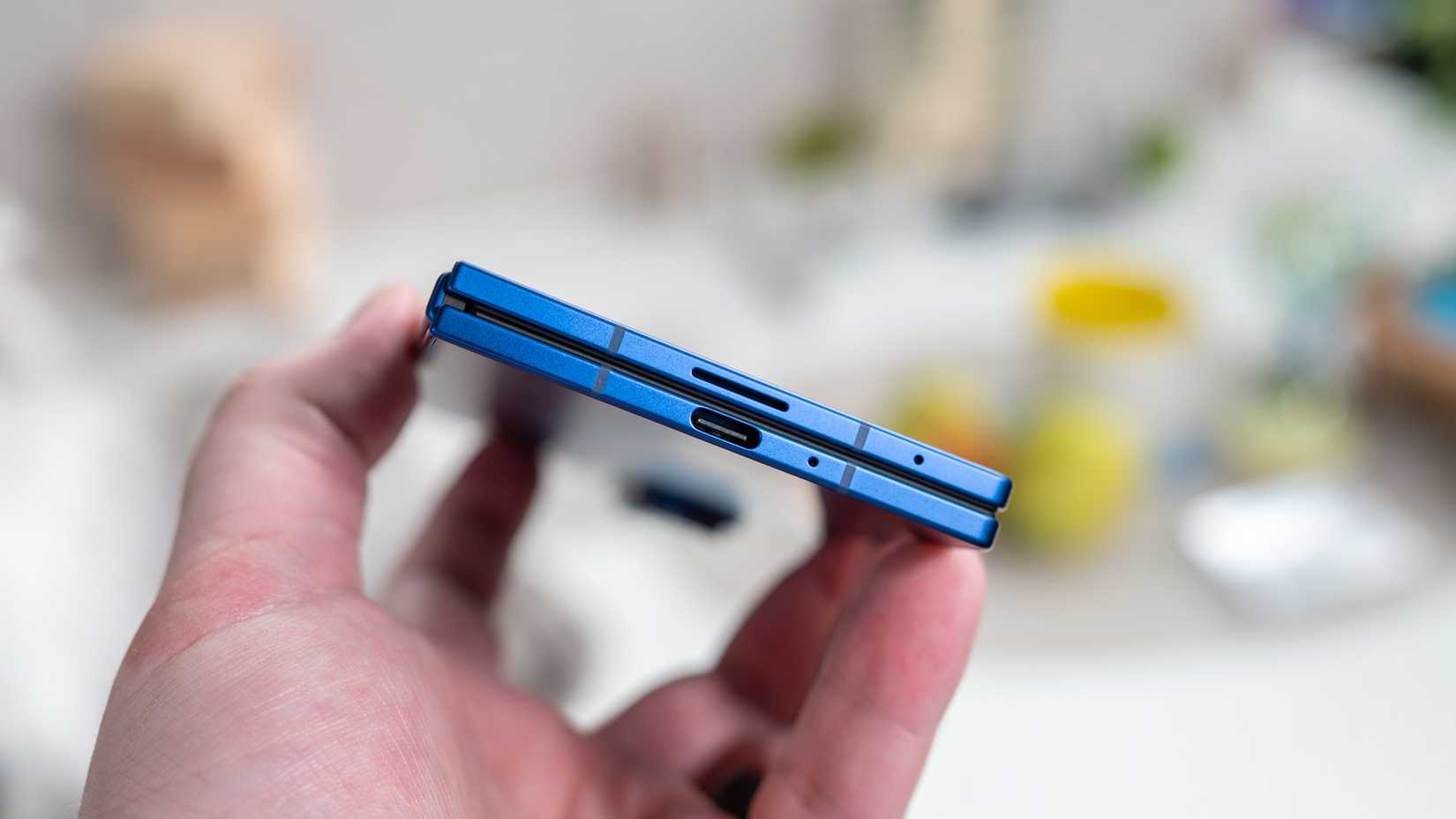 person holding the samsung galaxy z fold 7 folded showing the usb c port and hinge 54642360595 o