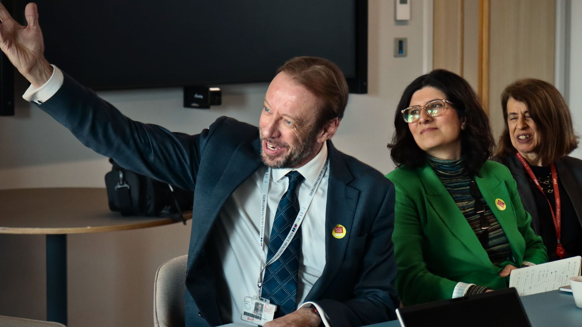 Man in a suit holding his hand up