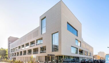 white brick facade wraps school group in france by brenac & gonzalez & associés