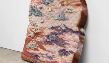 A sculpture of an oversized piece of moldy bread made from beads