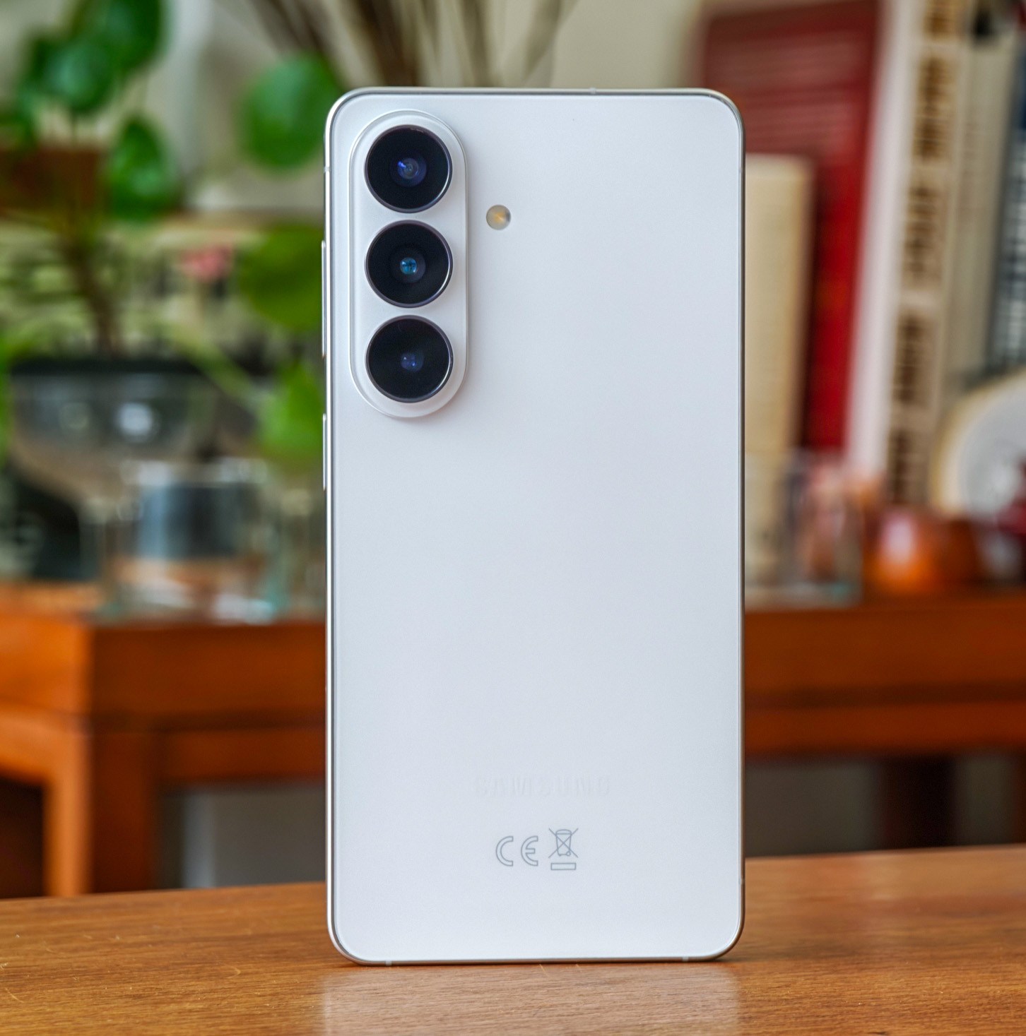 Photo of white Samsung Galaxy S26 on a wooden table