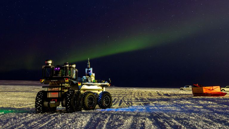 A robot on sea ice under the aurora borealis in Cambridge Bay, Canada. Pic: Reuters