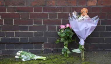 Flowers and a toy animal left near the Peabody Estate building in Horseferry Road. Pic: PA Wire