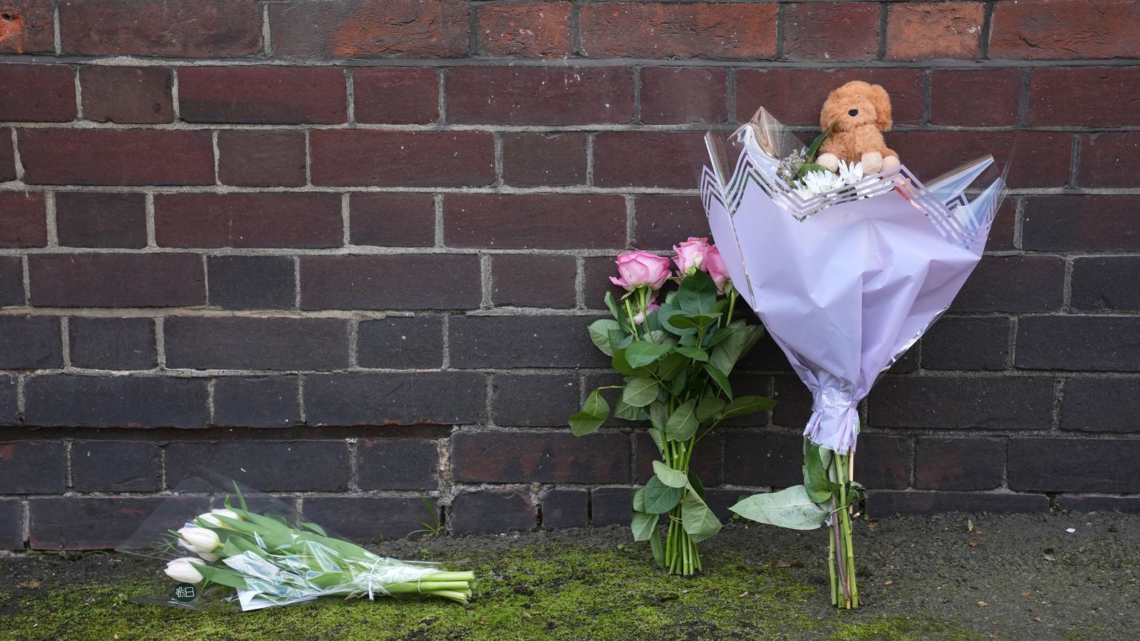 Flowers and a toy animal left near the Peabody Estate building in Horseferry Road. Pic: PA Wire