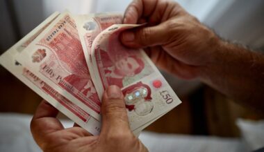 Close up of unrecognizable man counting £50 notes. Pic: iStock