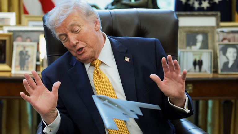 Trump looks at a model aircraft commemorating the US bombing raid against Iran's nuclear facilities. Pic: Reuters