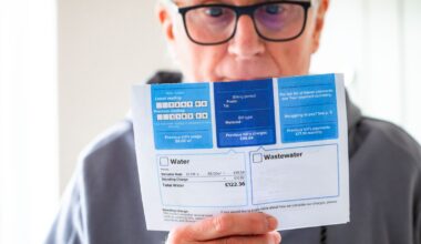 A man holds his water bill. Pic: iStock