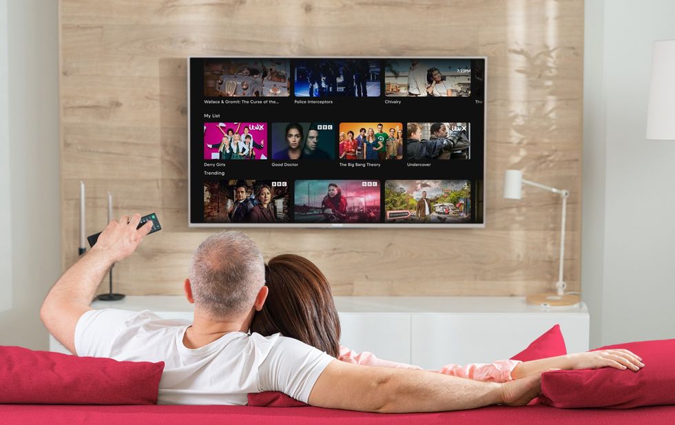 Smart TV in a living room with the Freely logo in the background with My List feature shown on-screen