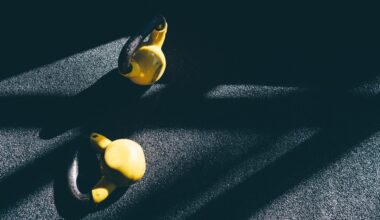 Two kettlebells lying on floor for farmer's carry exercise