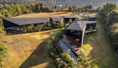 black concrete volumes carve mavra house into the mexican landscape