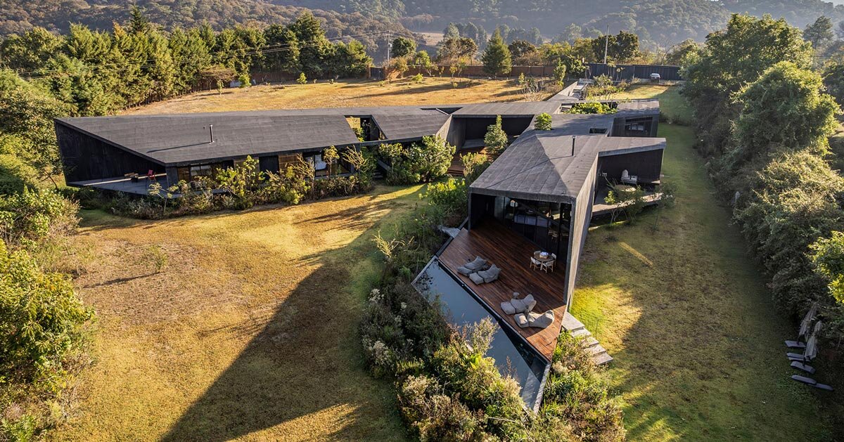 black concrete volumes carve mavra house into the mexican landscape