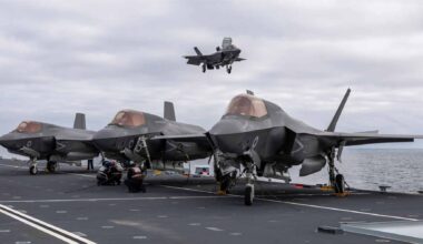 The British aircraft carrier HMS Prince of Wales navigating through icy Arctic waters during a naval deployment.