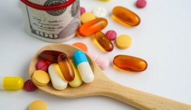 A pile of colorful pills sits in a wooden spoon.