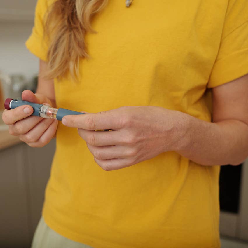woman holding expensive EpiPen