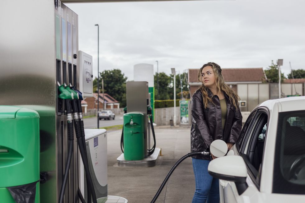 Woman filling up her car