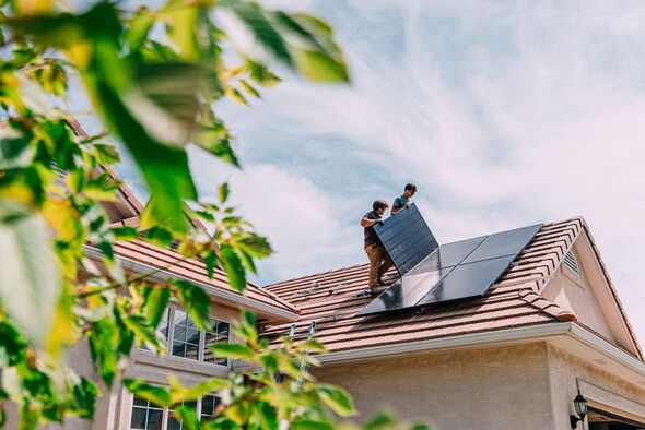 Young Homeowners installing Solar Panels on a Suburban Western USA Home