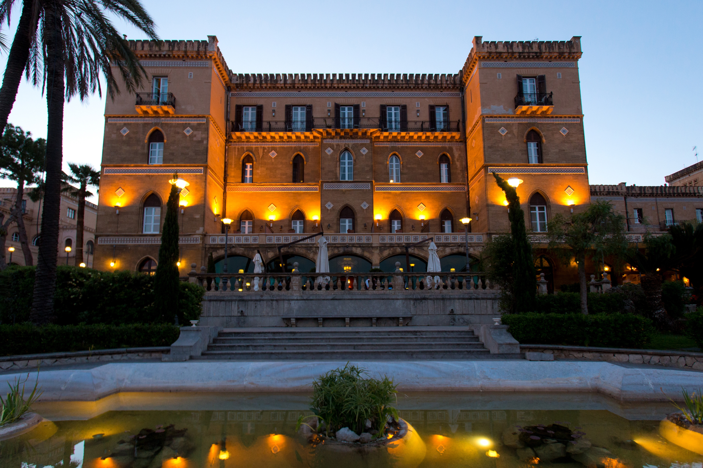 Grand Hotel Villa Igiea, Palermo, Sicily, Italy, Europe at twilight, illuminated by warm lights.