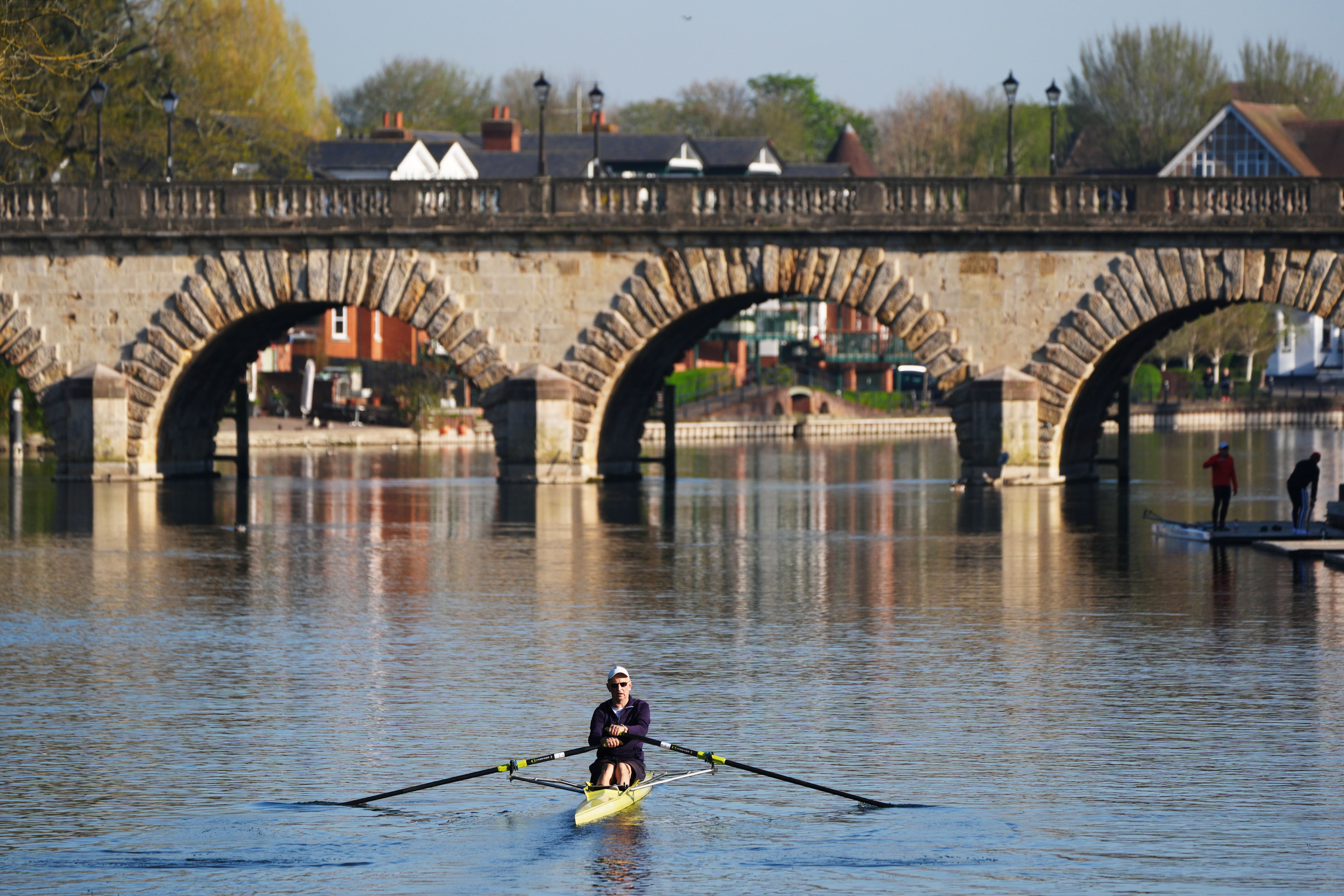 Rowers travel along the Thames near Maidenhead, Berkshire