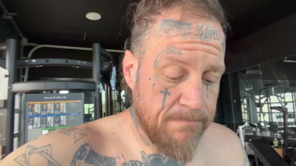 Jelly Roll looks anxious while shirtless.