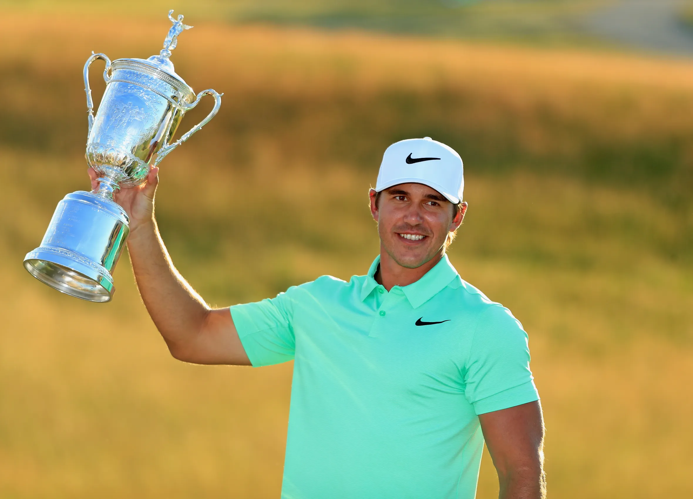 Brooks Koepka poses with the winner's trophy at the U.S. Open.