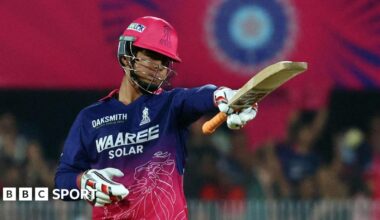 Rajasthan Royals batter Vaibhav Suryavanshi raises his bat after scoring a half-century against Royal Challengers Bengaluru