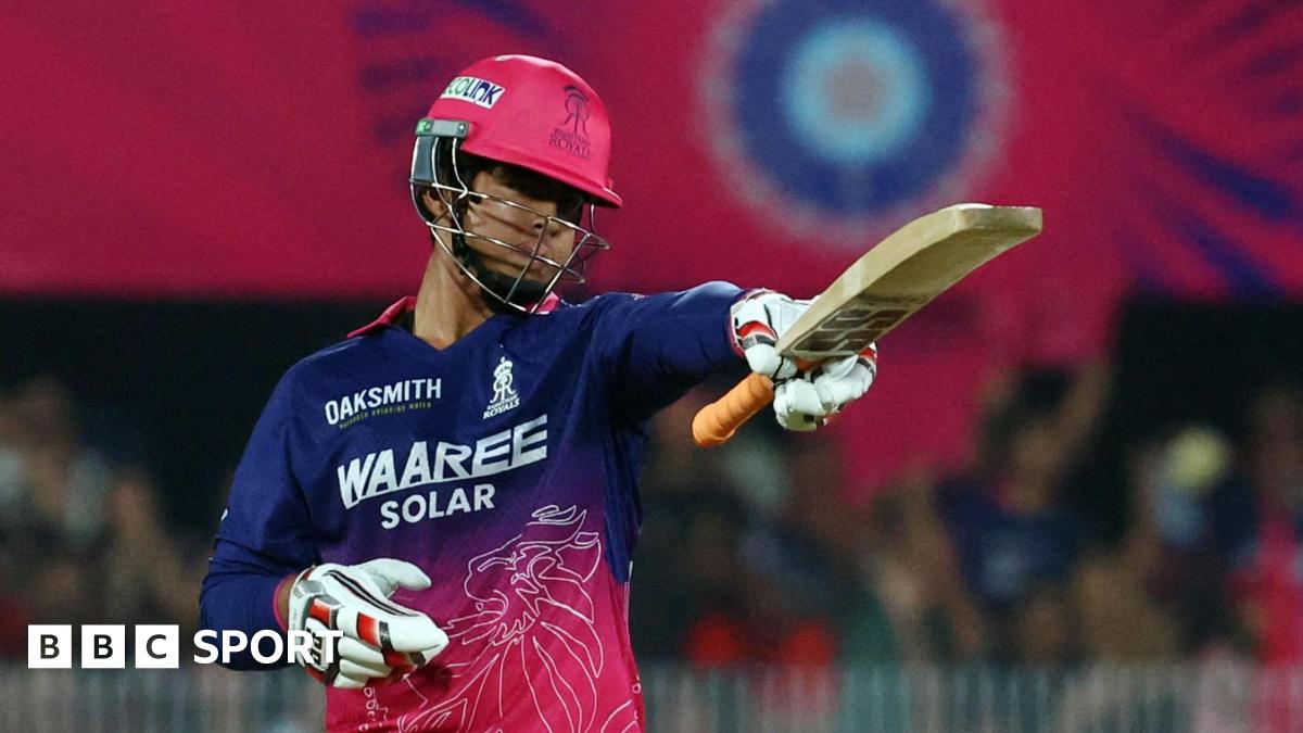 Rajasthan Royals batter Vaibhav Suryavanshi raises his bat after scoring a half-century against Royal Challengers Bengaluru