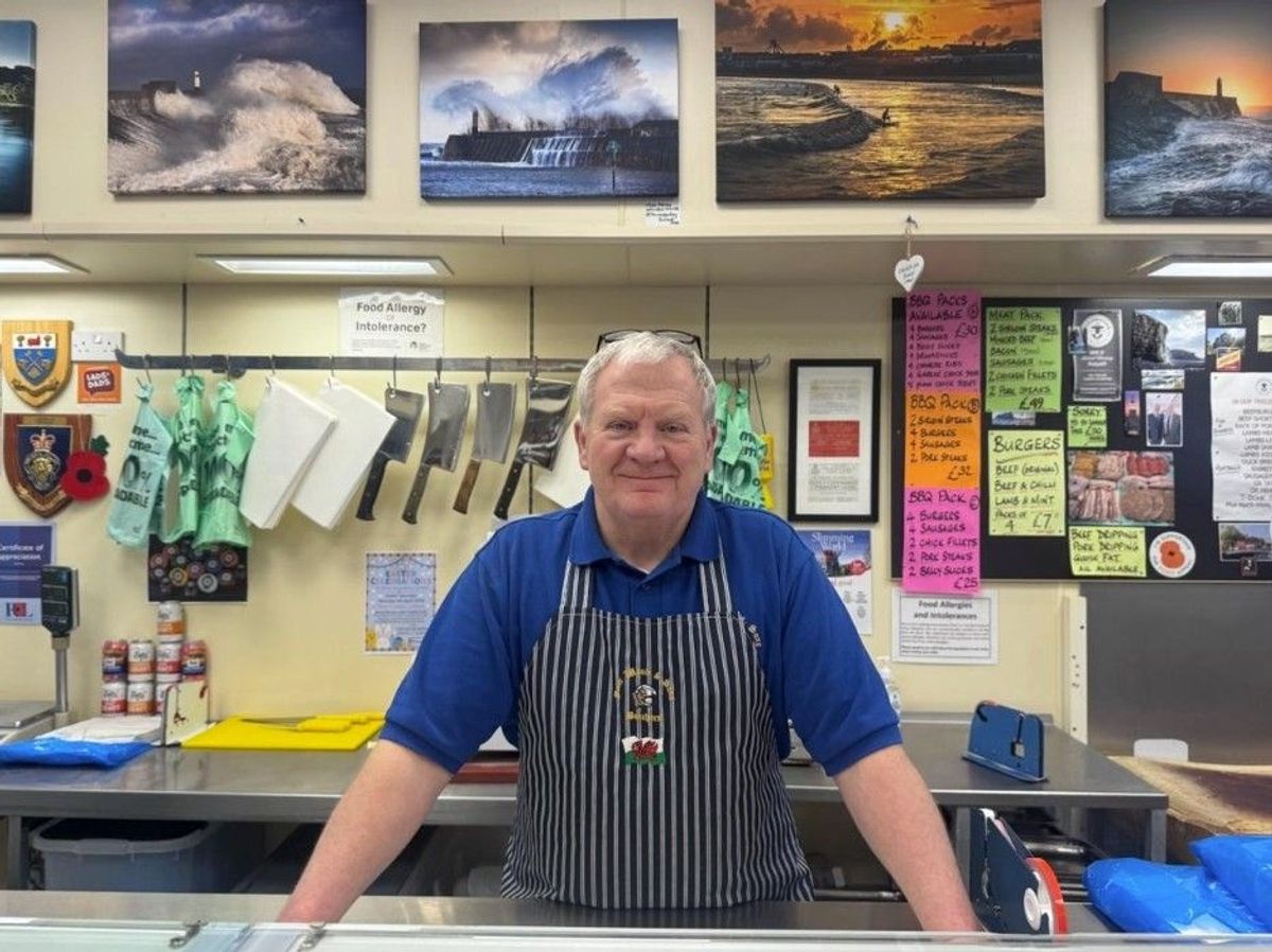 Tim is pictured here wearing his apron behind the till