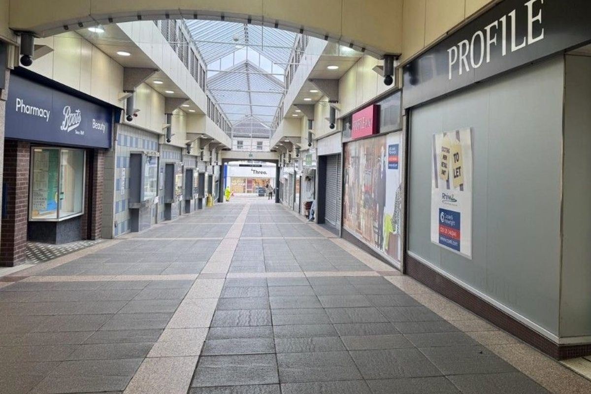 Empty shops in a small indoor shopping area