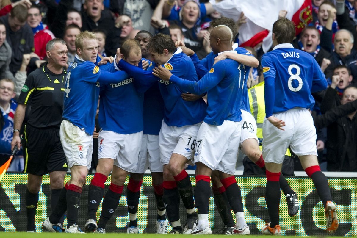 Steven Whittaker is mobbed by his Rangers teammates