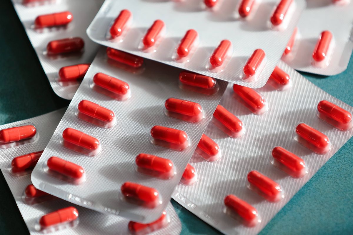 Dietary Supplement For Anemia Treatment. Tree Packs Of Iron Pills For Recovering Women's Health. Red Blister Packs With Ambient Sunlight