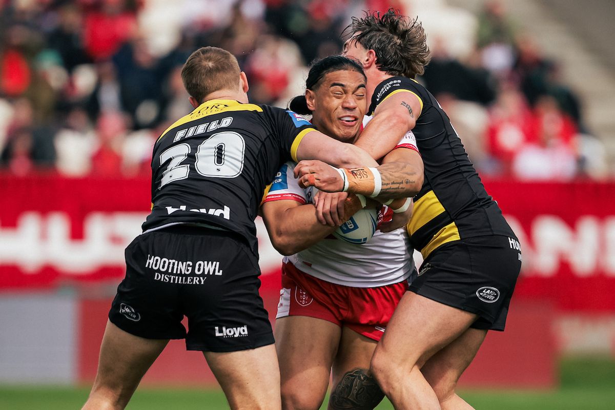 Tom Amone of Hull KR is tackled by Oli Field and Denive Balmforth of York